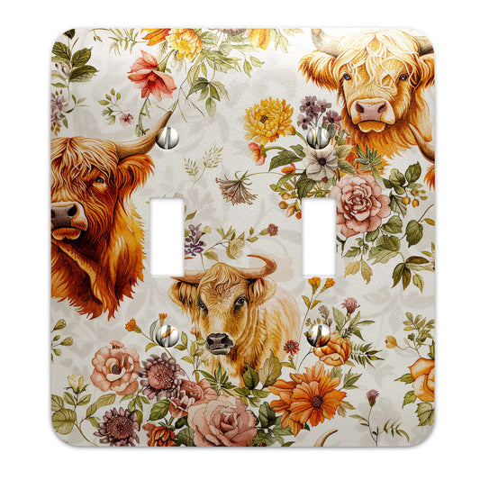 a light switch cover with two cows and flowers on it